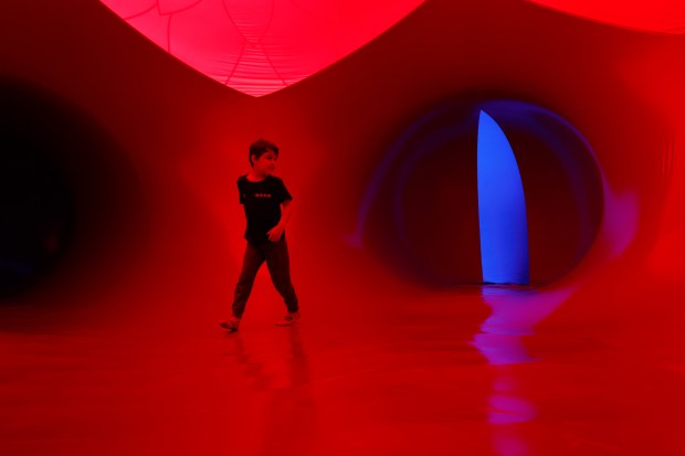 Cassius Guimaraes explorse the Architects of Air Arborialis walk-through experience at the Seneff Arts Plaza at the Dr. Phillips Center for the Performing Arts on Friday, 2026. The large, cavernous 17,000-square-foot inflatable structure of fabric and air creates a colorful labyrinth connected by domes and vibrant walkways. It is filled with ephemeral music for an otherworldly experience that guests can explore as part of Immerse 2026.(Rich Pope/Orlando Sentinel)