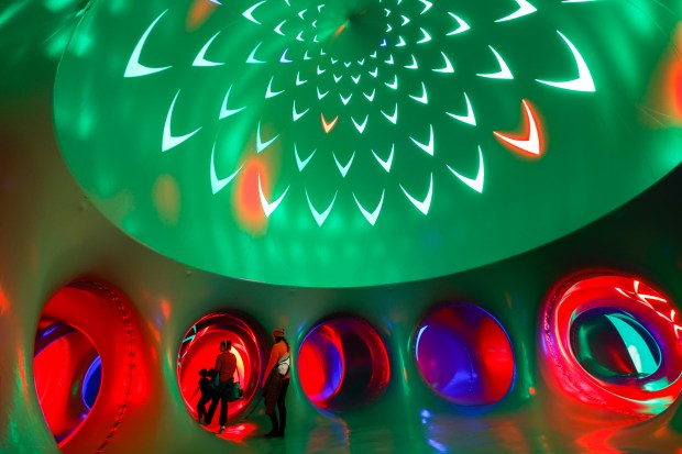 Sabrina, Allison and Cassius Guimaraes explore the Architects of Air Arborialis walk-through experience at the Seneff Arts Plaza at the Dr. Phillips Center for the Performing Arts on Friday, 2026. The large, cavernous 17,000-square-foot inflatable structure of fabric and air creates a colorful labyrinth connected by domes and vibrant walkways. It is filled with ephemeral music for an otherworldly experience that guests can explore as part of Immerse 2026. (Rich Pope/Orlando Sentinel)