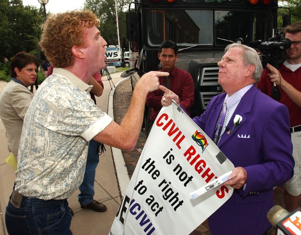 Royce Matthew, left, argues with anti-gay protester Rev. John Butler Book outside the opening ceremonies and a party for the 13th annual Gay Days in Orlando on June 3, 2003. Gay Days started out as a single day in 1991 when friends from a gay computer bulletin board service informally decided to get together at the Magic Kingdom. While Disney didn't sponsor Gay Days, the theme park was the center of its activities. (Orlando Sentinel file)
