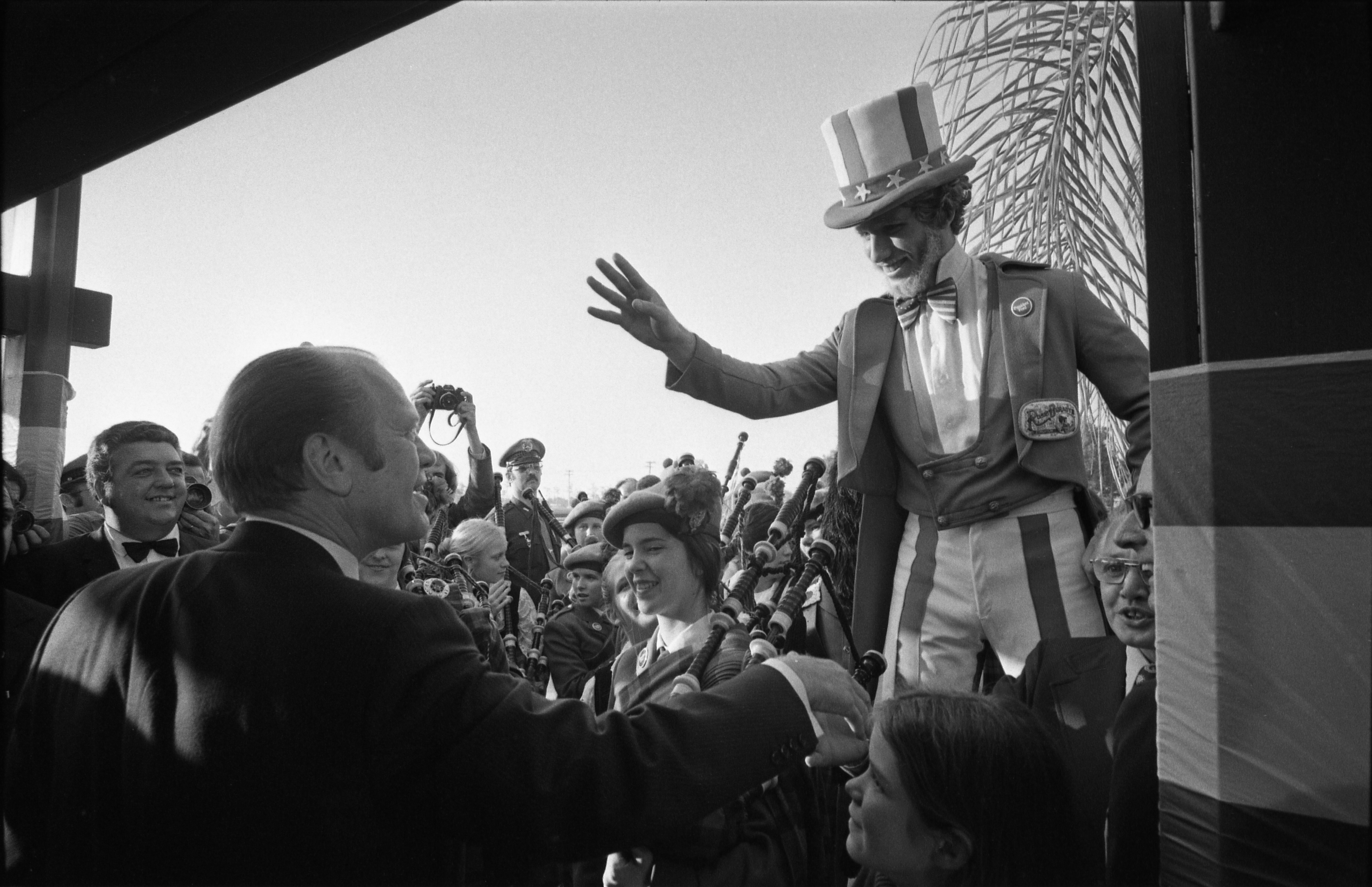 President Gerald Ford greets bagpipe players and man in Uncle...