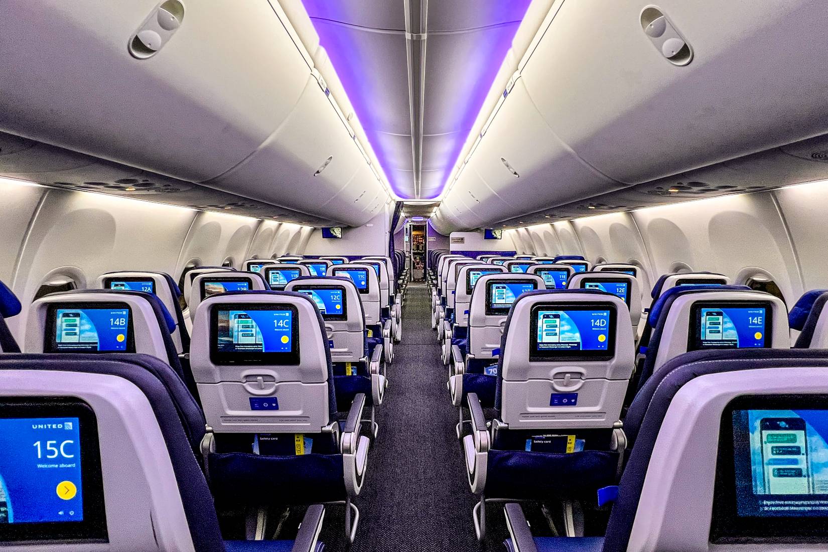 A back-to-front view of a United Airlines 737 Max aircraft cabin with empty seats