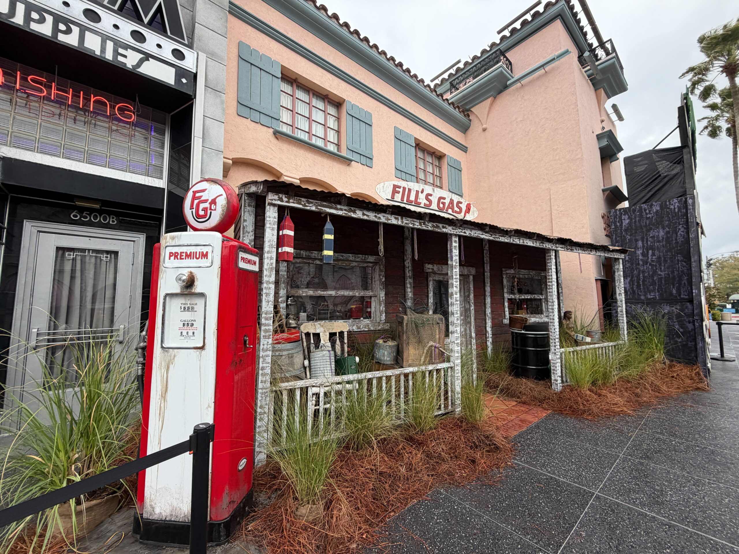 To the side of the main entrance is a patio add-on to the facade resembling a rundown gas station. A "Fill's Gas" sign is atop the patio roof.