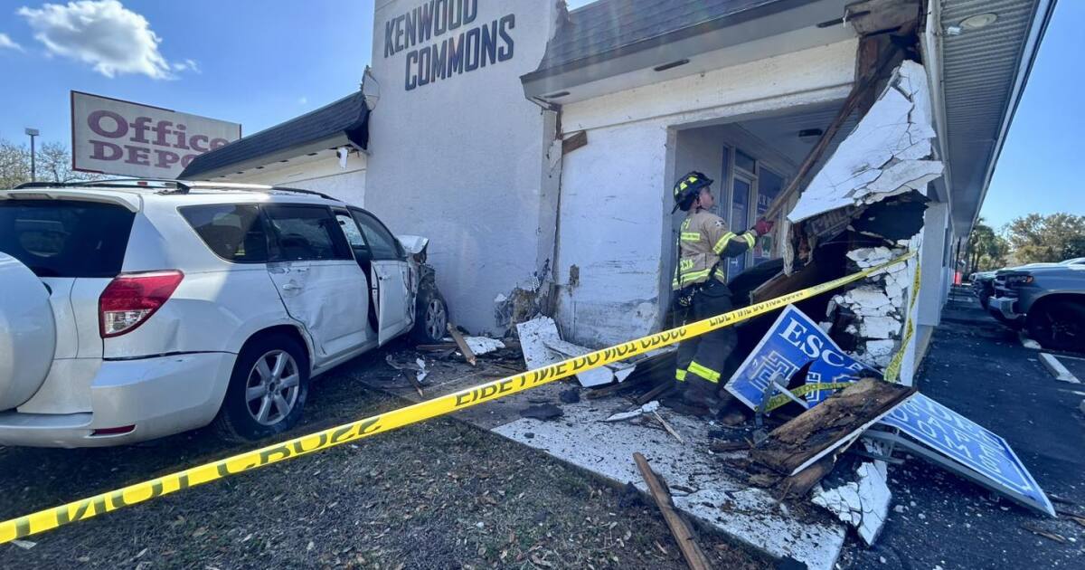 Car crash damages building exterior at College Parkway and Kenwood Lane
