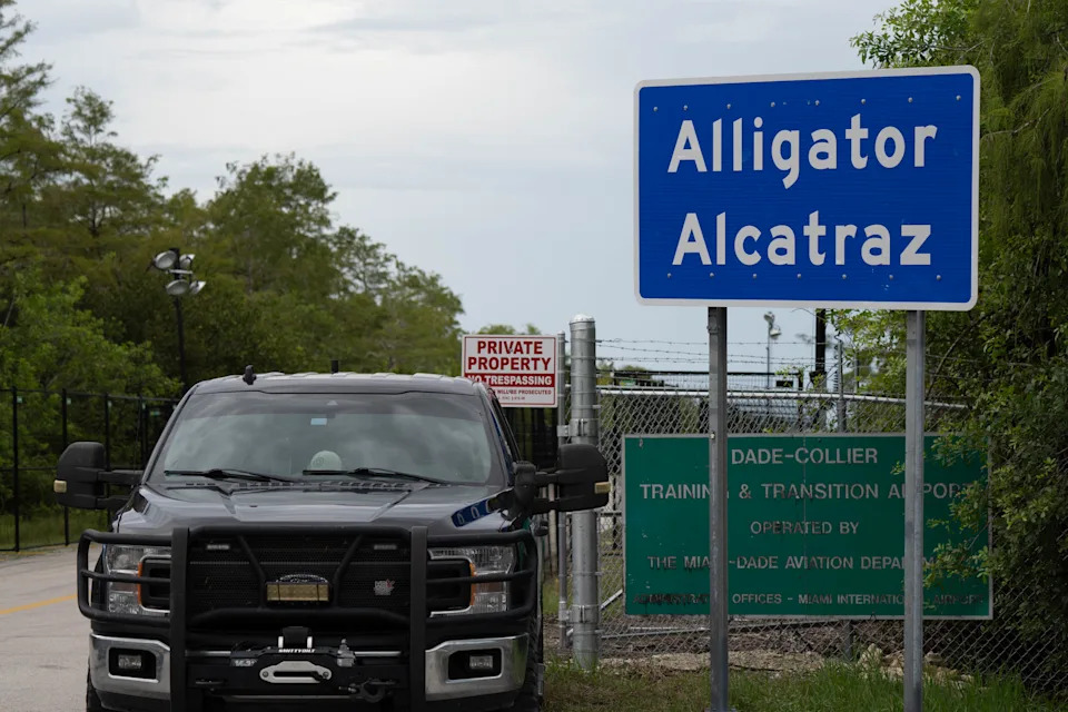 Police officers park outside Alligator Alcatraz in Ochopee, Florida, during the vigil Aug. 10, 2025.