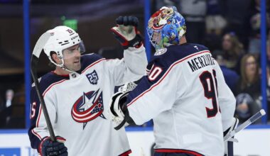 Blue Jackets defenseman Dante Fabbro celebrates an empty net goal with goaltender Elvis Merzlikins, who picked up the assist.