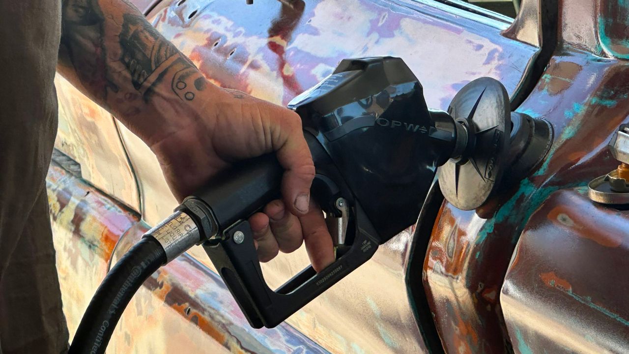 A man pumps gas into his truck. (Spectrum Bay News 9/Sarah Blazonis)