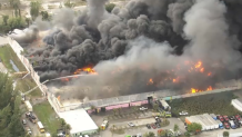 Crews battle a warehouse fire in northwest Miami-Dade on March 5, 2026.
