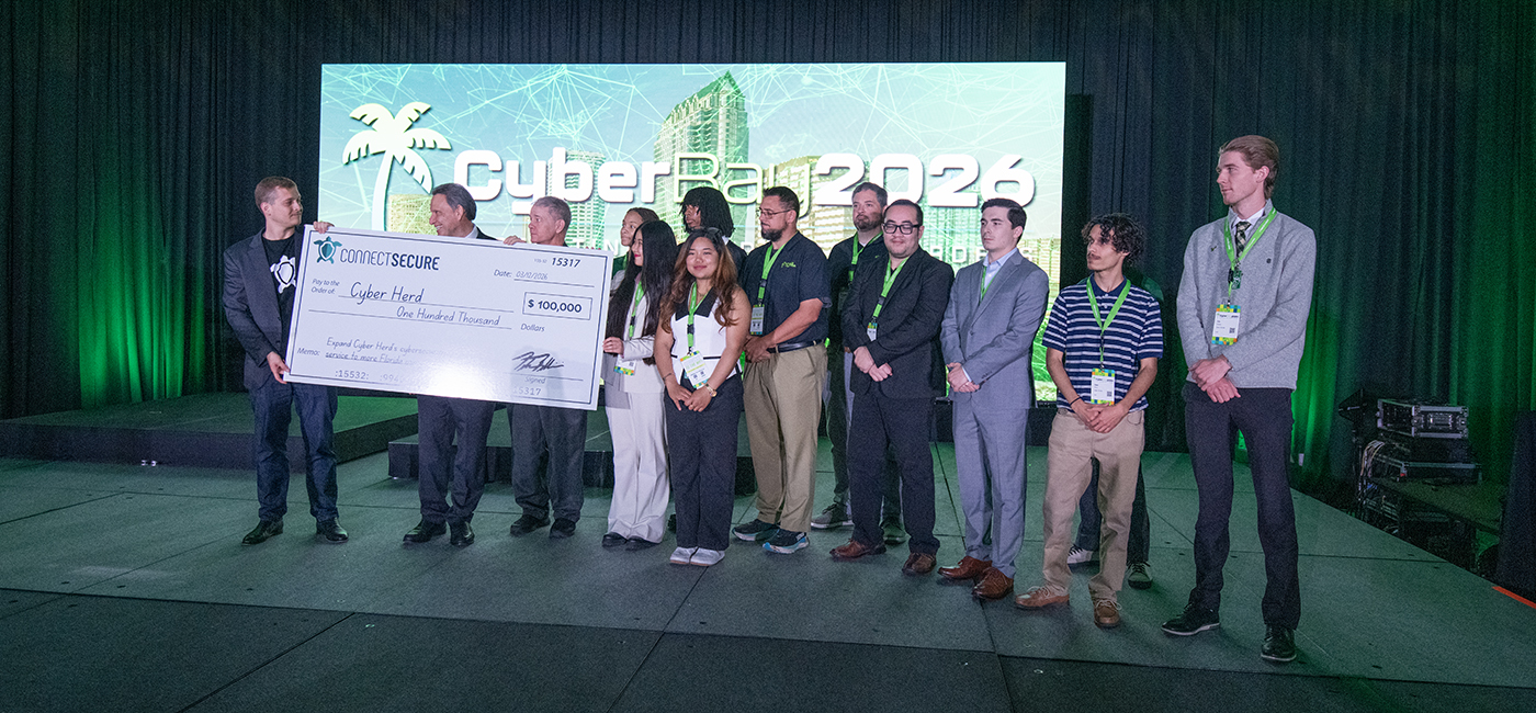 University of South Florida students and the university president accept an oversized check from Peter Bellini of connect secure.