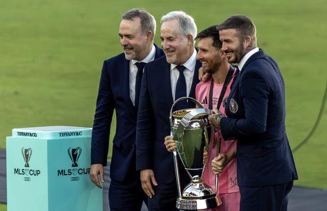 Inter Miami co-owners Jose Mas, Jorge Mas and David Beckham pose with the Philip F. Anschutz Trophy after their MLS Cup final win over the Vancouver Whitecaps at Chase Stadium on Saturday, Dec. 6, 2025, in Fort Lauderdale, Fla.