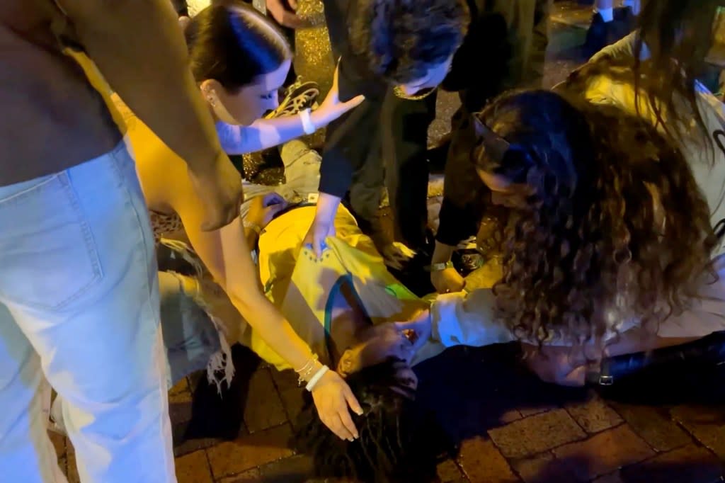 People checking on the Spring Breaker who got knocked out. Romaine Maurice for NY Post