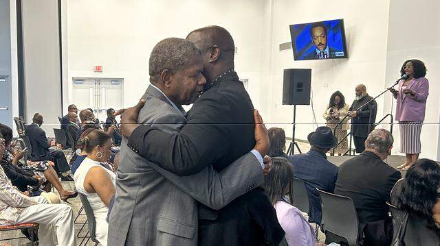 Abel Jean-Simon Zephir, left, one of the first Haitians to arrive in Miami by boat, is greeted by Rep. Wallace Aristide on Saturday, March 21, 2026, during a ceremony to honor the late Rev. Jesse Jackson, who died on Feb. 17, 2026. Jackson was a pivotal voice in the Haitian immigration struggle in Miami during the ‘80s and ‘90s. 