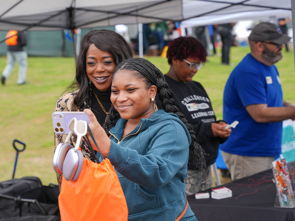 Florida A&M University President Marva Johnson, J.D., shares a moment with a student during the Harambee Festival, capturing the spirit of connection and community on campus.