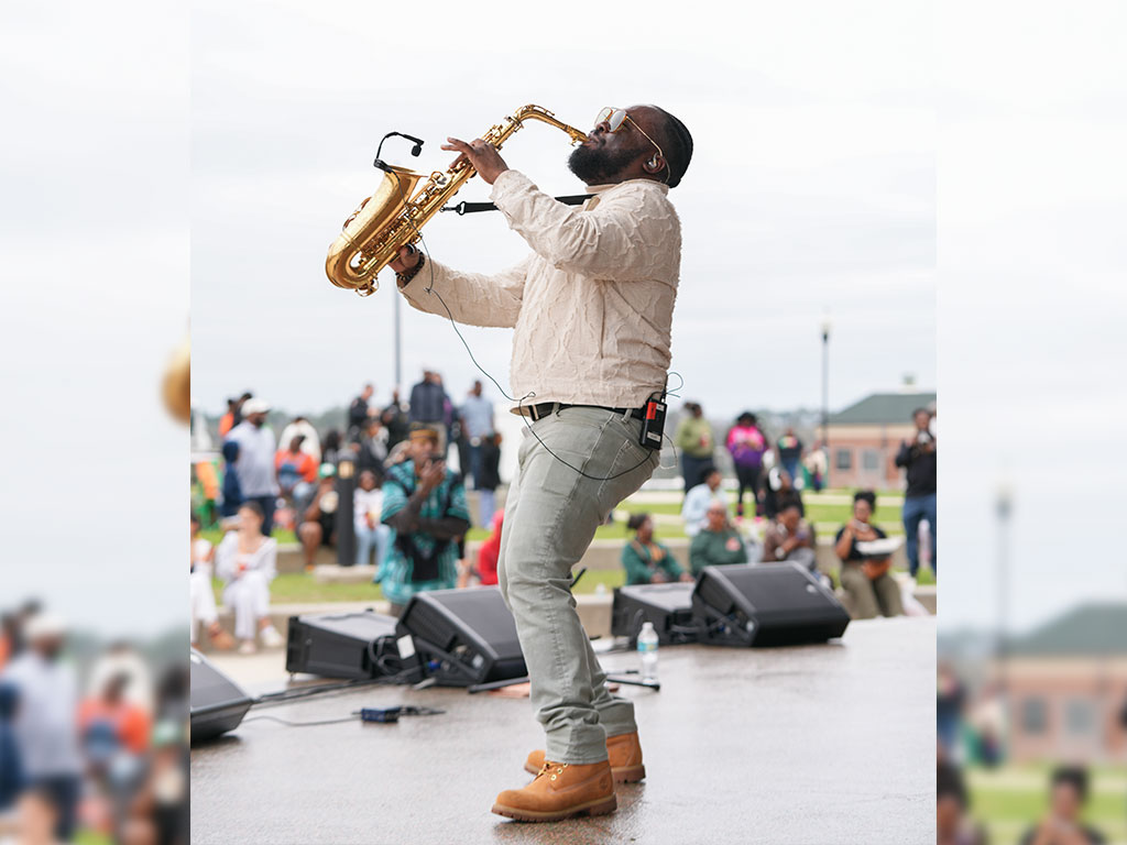 A saxophonist delivers an electrifying performance during the Harambee Festival at Florida A&M University’s Will Packer Amphitheater, adding to the day’s vibrant celebration of culture and music.