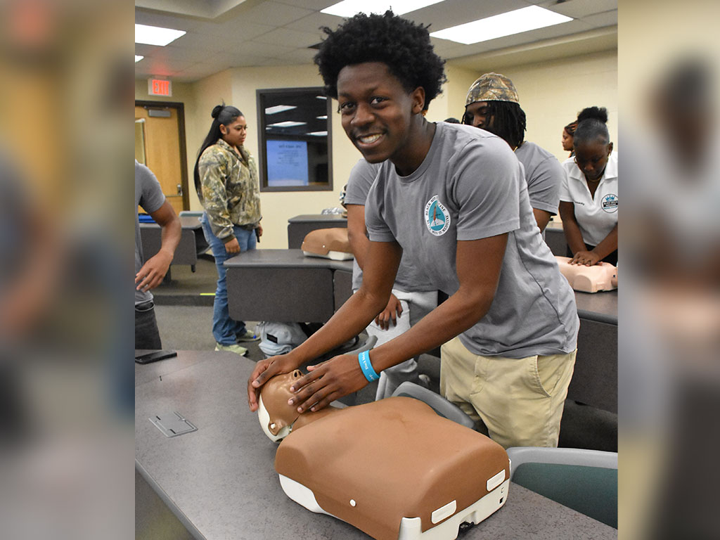 A Florida A&M University student practices CPR compressions during a hands-on certification training designed to prepare students to respond to real-life medical emergencies. (Photo courtesy of Willie Williams)