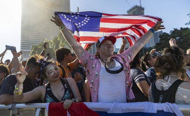 Addel Perez, from Atlanta, holds a flag as Alan Walker performs during Ultra Music Festival’s 26th anniversary at Bayfront Park on Saturday, March 28, 2026, in downtown Miami, Fla.