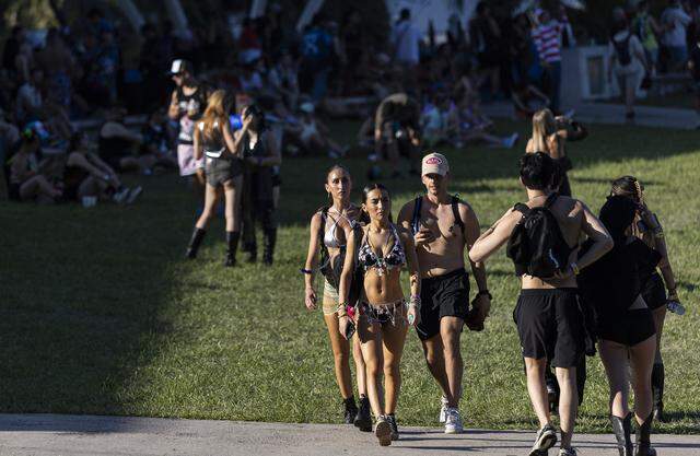 People walk through Bayfront Park as they attend Ultra Music Festival’s 26th anniversary on Saturday, March 28, 2026, in downtown Miami, Fla.