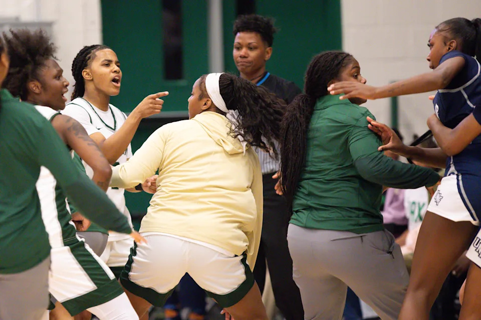 Jacksonville University guard Tatum Brown (2) exchanges words with University of North Florida forward Dezuray McGill (30) during a scuffle in the fourth period. [Doug Engle/Florida Times-Union]