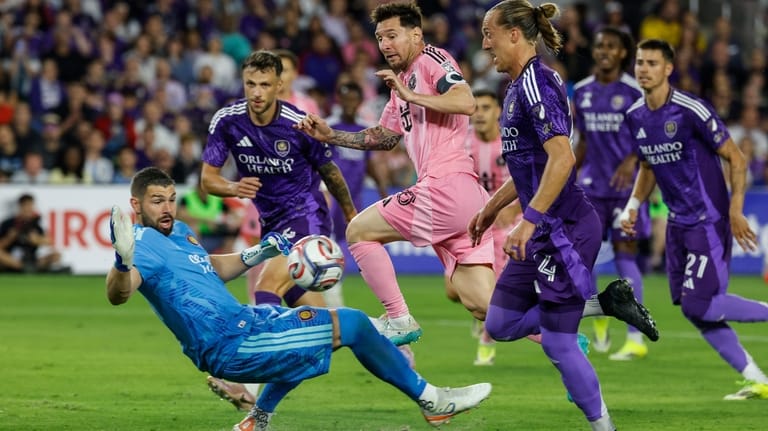 Inter Miami CF forward Lionel Messi, center, goal attempt is...