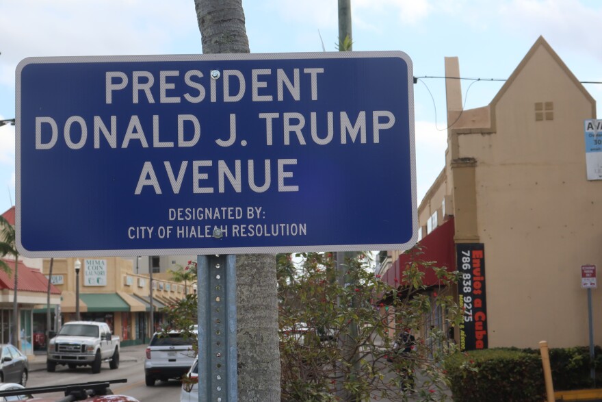 Palm Avenue was re-named to President Donald J. Trump Avenue in 2023. Along the avenue, many business that ship goods to Cuba operate, as seen in a background sign. Yet even while the shops draw a steady stream of local customers, their very existence is controversial to many.