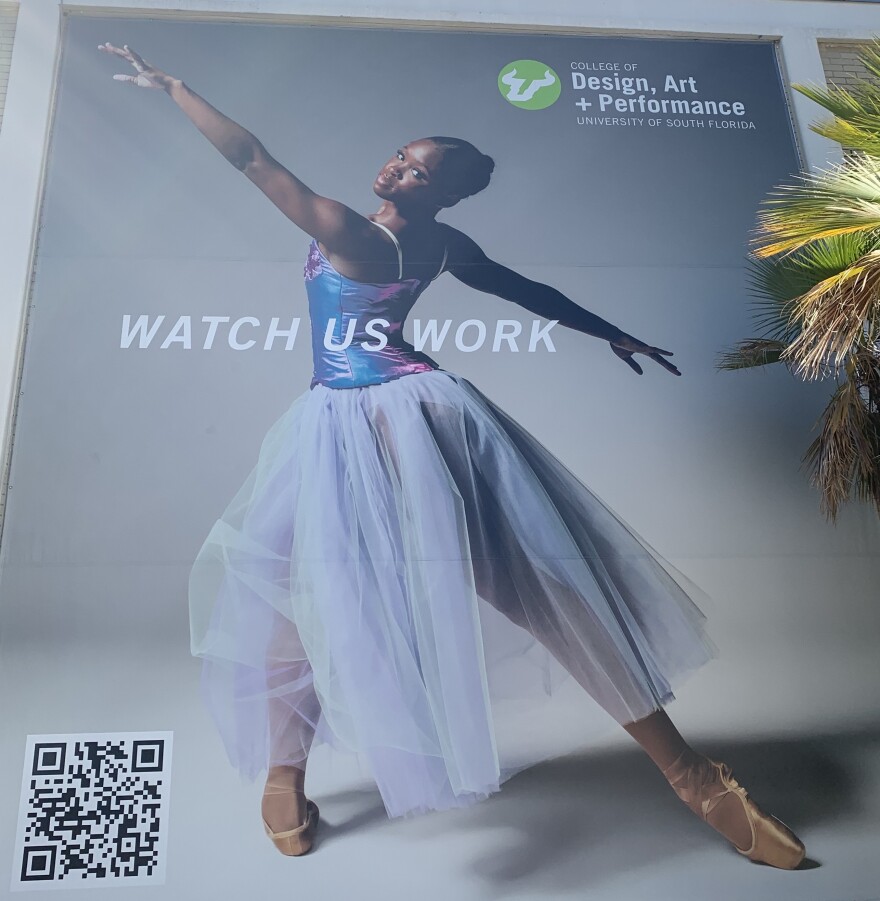 A ballerina in a shimmery  top and a long tulle skirt dances en pointe. 