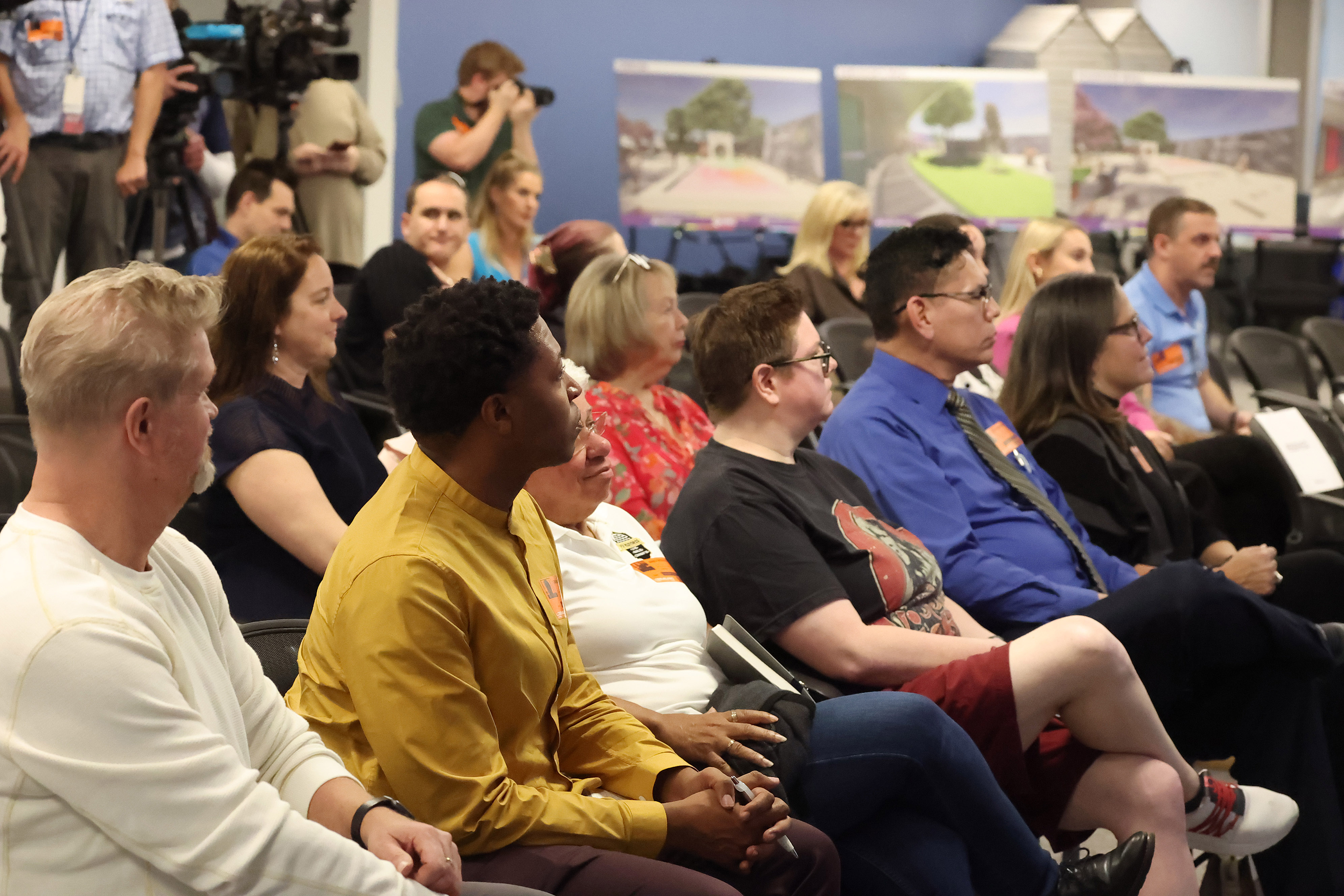 Attendees listen during a meeting by the City of Orlando...