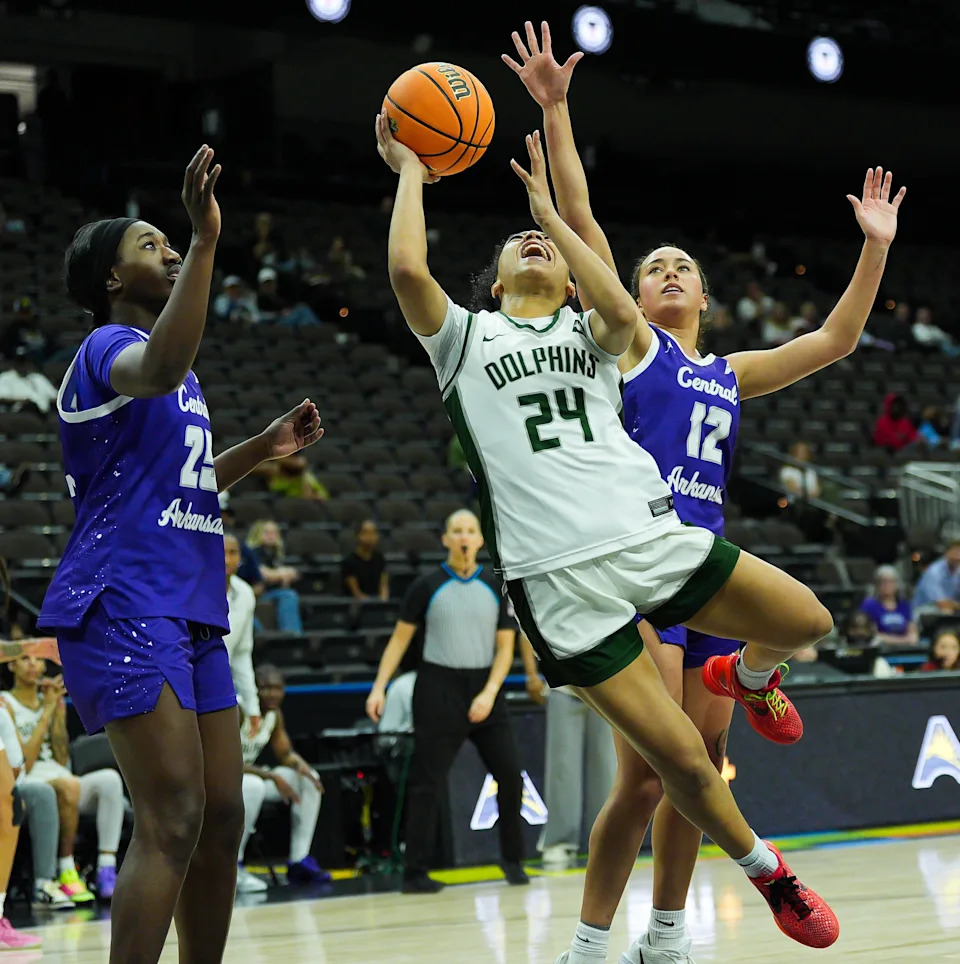 Jacksonville Dolphins guard Makiya Miller (24) drives to the basket under Central Arkansas Sugar Bears forward Laylah Reese (12) during the fourth period in the women’s ASUN semifinal against Jacksonville University and Central Arkansas at the VyStar Veterans Memorial Arena in Jacksonville, Fla. Saturday March 7, 2026. JU defeated Central Arkansas 67-58. [Doug Engle/Florida Times-Union]