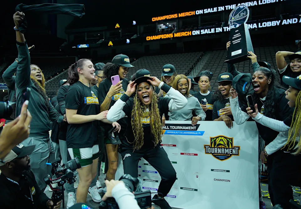 Jacksonville Dolphins forward Mariyah Brown (20) center, celebrates with teammates after Jacksonville University defeated Austin Peay 66-63 in overtime in the ASUN Women's Basketball Tournament Championship at VyStar Veterans Memorial Arena Monday, March 9, 2026 in Jacksonville, Fla. [Doug Engle/Florida Times-Union]