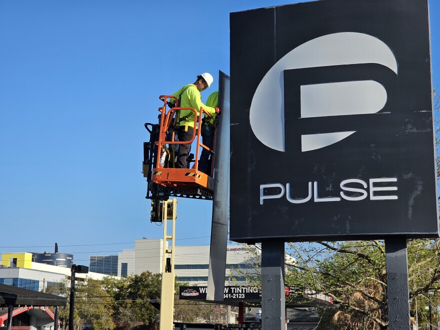 Crews removed panels making up the Pulse Nightclub sign towering over Orange Avenue on Tuesday morning. The top portion of the sign is scheduled to be removed on Wednesday.