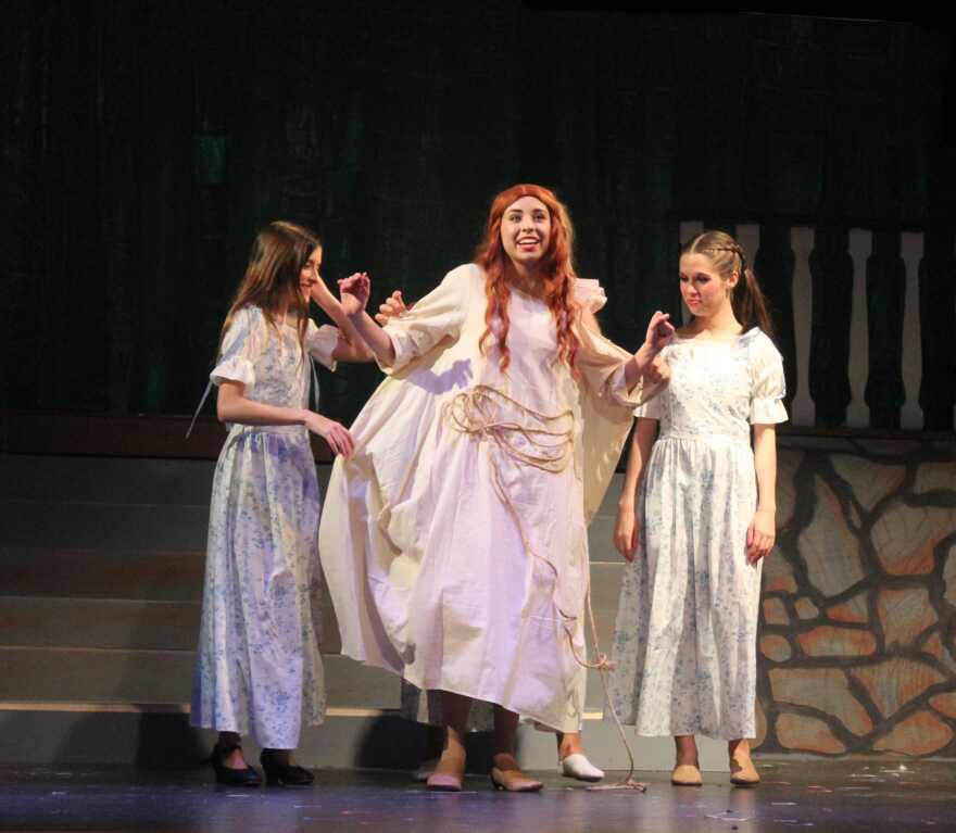 Because it's fastened from behind by magnets, Ariel's maids are able to remove outer dress in a matter of seconds to complete transformation into her satiny pink dress.