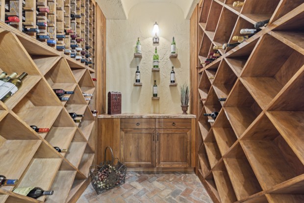 The spacious wine cellar has ample storage for entertaining. (Photo by Michael Pelzer / Uneek Luxury)