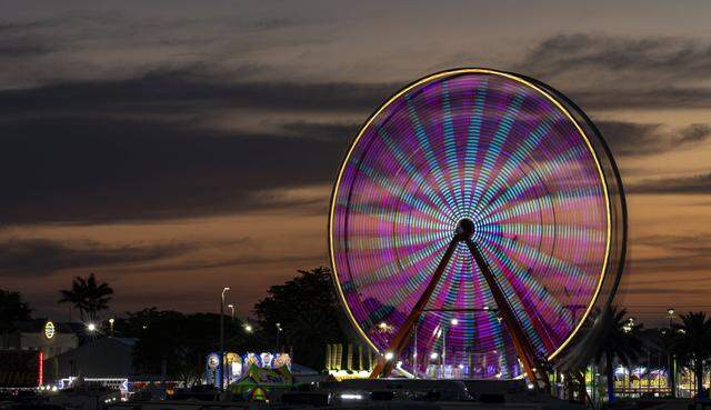 Guests ride a ferris wheel attraction during the opening day of the 74th annual Miami-Dade County Youth Fair on Thursday, March 12, 2026, in Miami, Fla.