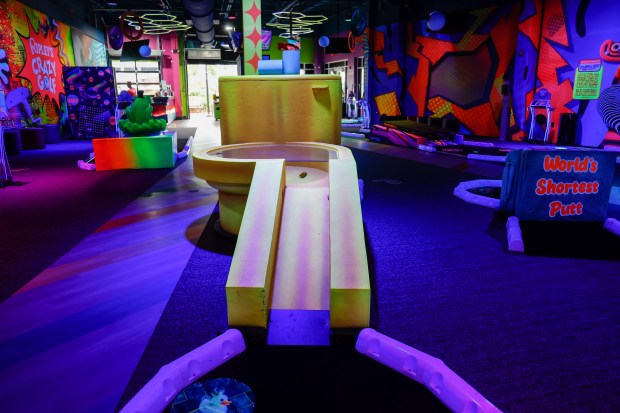 The Ripley's Crazy Golf golden toilet hole sends players' balls for a swirl toward the cup at the indoor mini golf attraction at Icon Park on Friday, March 13, 2026. (Rich Pope/Orlando Sentinel)