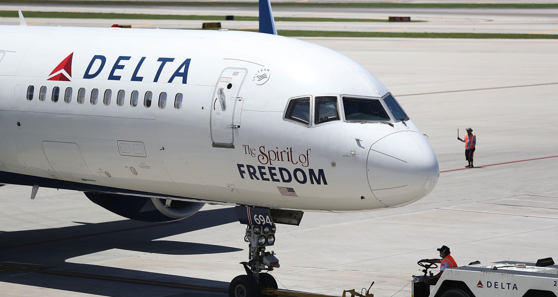 Air travellers wearing protective face masks, amid the coronavirus disease (COVID-19) pandemic, walk at JetBlue Terminal 5 at JFK International airport in New York, U.S., November 16, 2021.