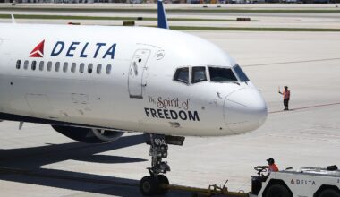 Air travellers wearing protective face masks, amid the coronavirus disease (COVID-19) pandemic, walk at JetBlue Terminal 5 at JFK International airport in New York, U.S., November 16, 2021.