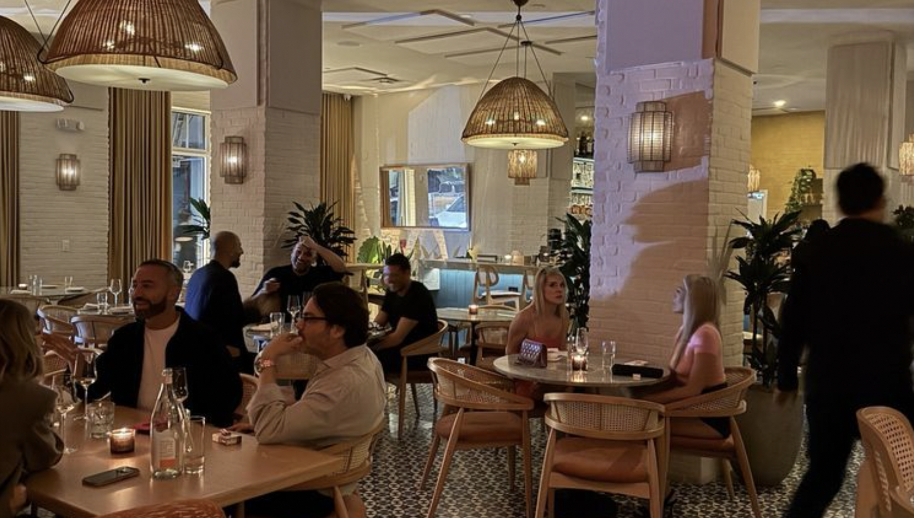 a dining room with tables and a few scattered guests