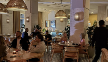a dining room with tables and a few scattered guests