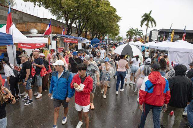 Crowds of people filled 8th street in Little Havana despite the relentless rain during Calle Ocho festival on Sunday, March 15, 2026 . Andrew Uloza / for Miami Herald
