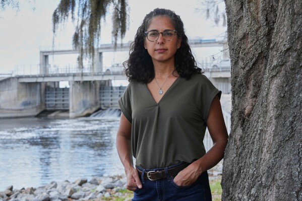 Nina Bhattacharyya, executive director of Florida Defenders of the Environment, stands near the Kirkpatrick Dam on Wednesday, March 4, 2026, in Palatka, Fla. (AP Photo/Marta Lavandier)