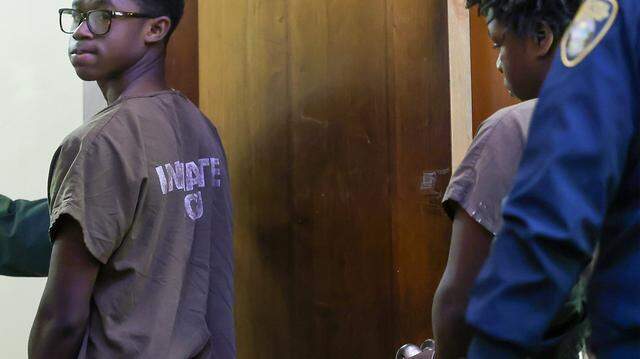 Nelson Nunez, left, looks back as he and Jusiah Jones, right, exit the courtroom after being charged as adults in the rape of a 12-year-old girl, and appeared in Judge Richard Hirsch's Courtroom 4-8 for their bond hearing on Wednesday, March 18, 2026, at the Richard E. Gershwin Justice Building in Miami, Florida.