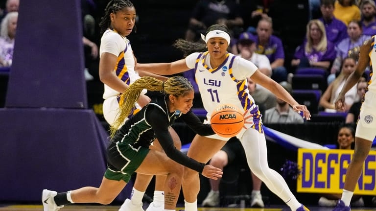 Jacksonville guard Aniah Smith loses the ball as she trips...