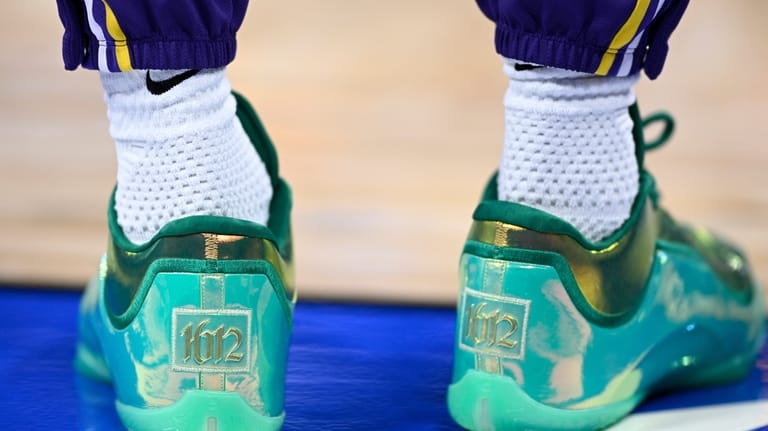 Los Angeles Lakers forward LeBron James wears shoes commemorating his...