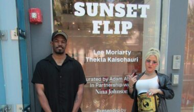 Two wrestlers discuss their artwork at their exhibit in Miami