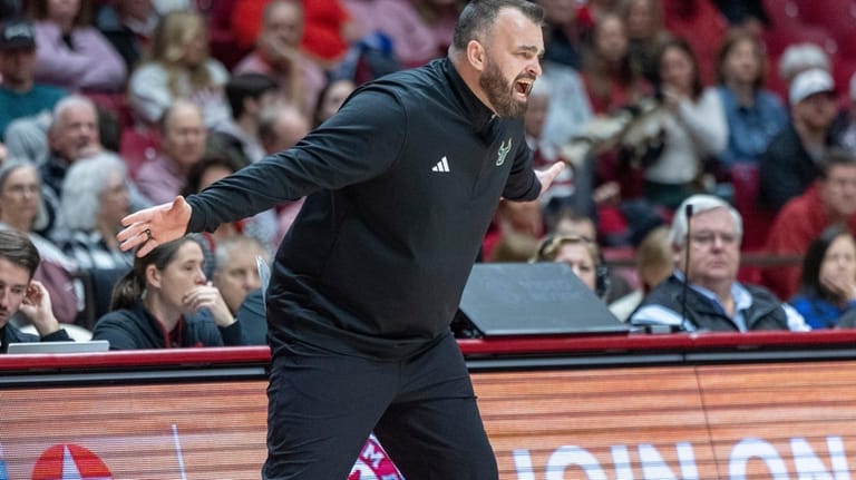 South Florida head coach Bryan Hodgson works with his team...