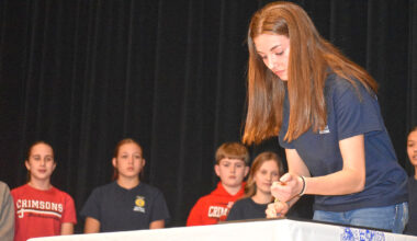 Jacksonville Middle School eighth-grader Marley Schlieker signs a charter establishing the school's FFA chapter. 