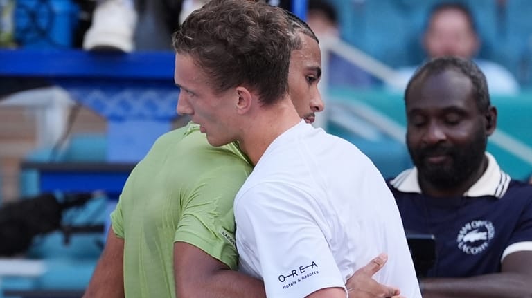 Jiri Lehecka of the Czech Republic, right, hugs Arthur Fils...