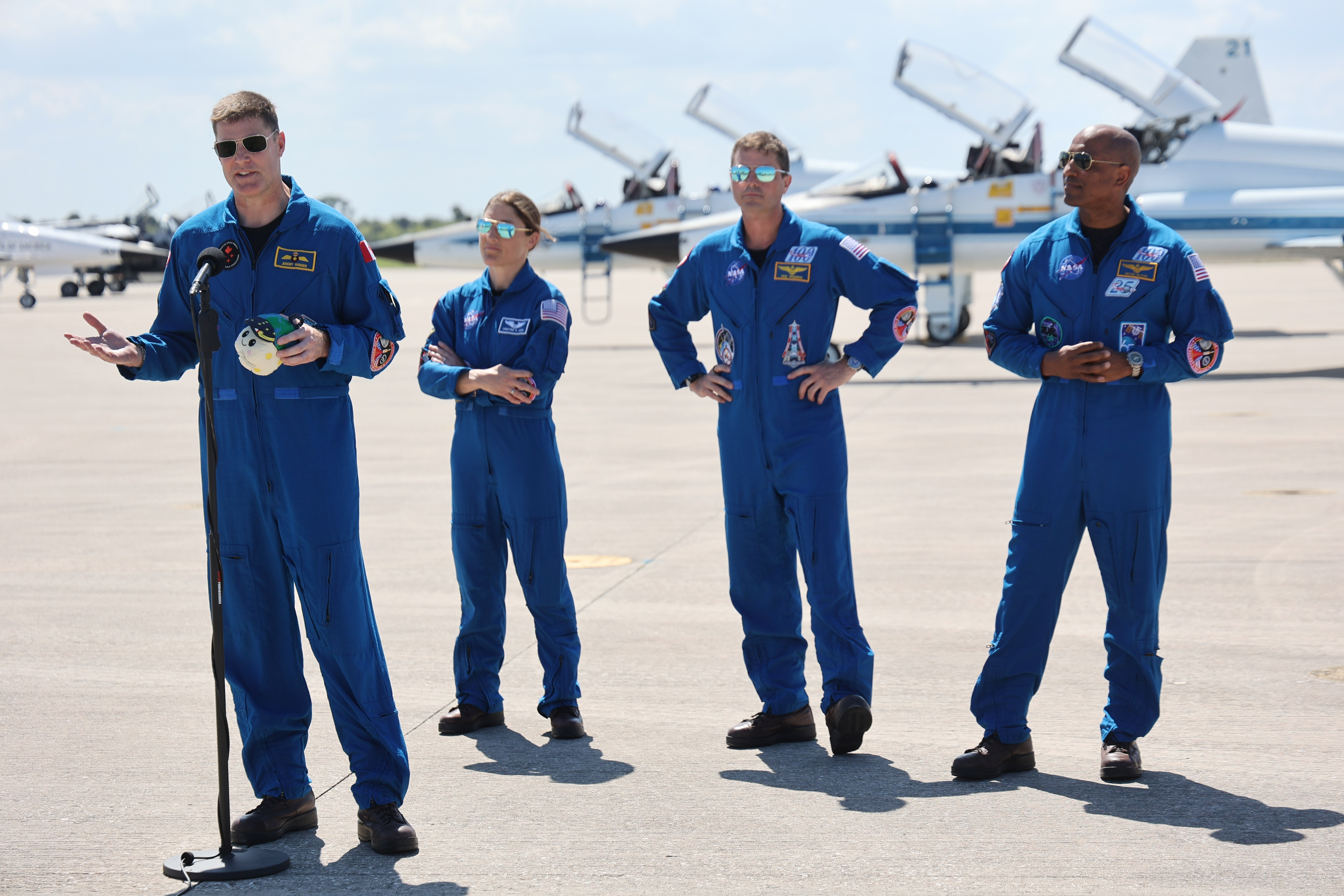 From left, Artemis II crew mission specialists Jeremy Hansen and...