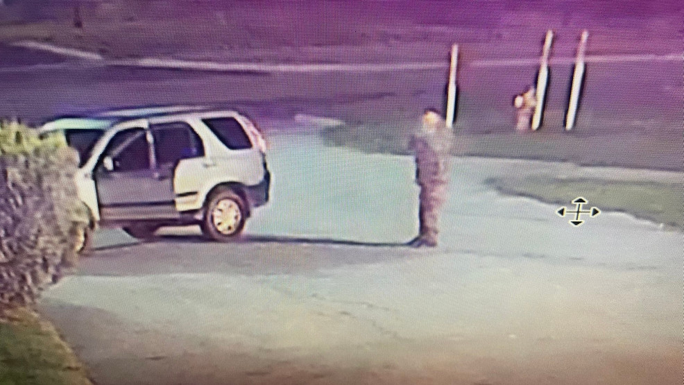 This screenshot from security camera footage shows a man firing a rifle at vehicles at the Michigan State Police Sault Ste. Marie Post on Sept. 6, 2023. (Michigan State Police)