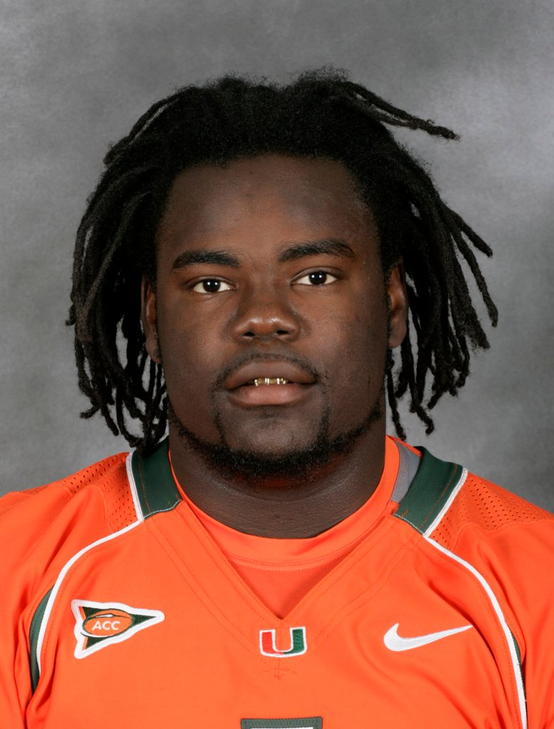Bryan Pata, a University of Miami defensive end, wearing an orange jersey with dreadlocks and a gold grill.