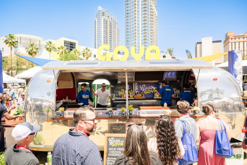 Guests line up at a GOYA food stand during the Tampa Bay Wine & Food Festival Grand Tasting in downtown Tampa.