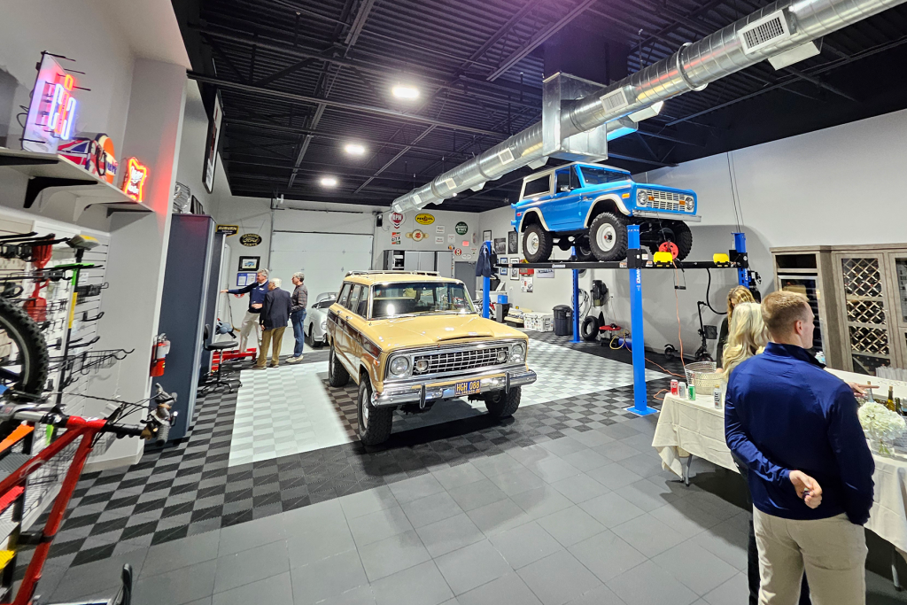 interior showroom space with vehicles, bikes on bike racks, and more